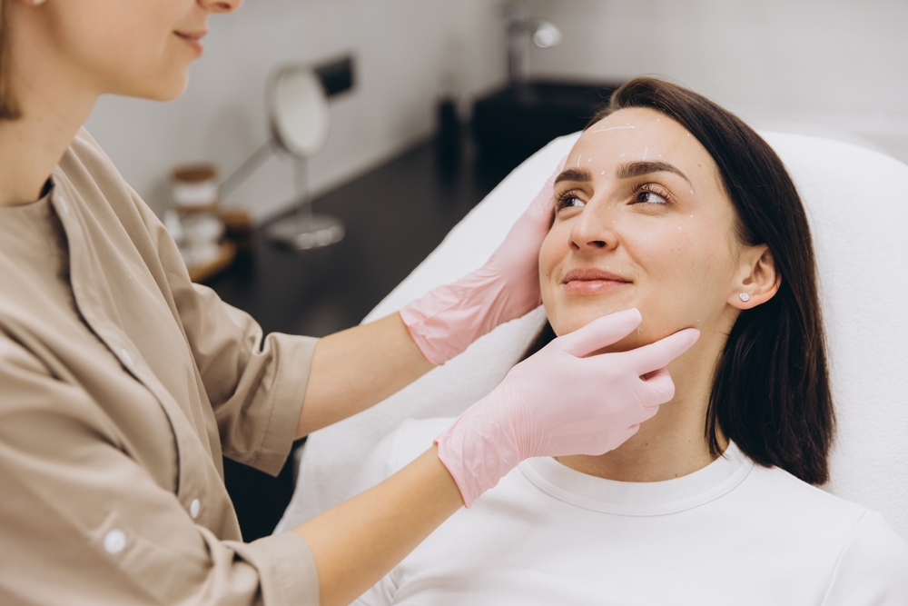 Beautician,Drawing,Marks,On,Patient’s,Face,Before,Botulinum,Toxin,Injections Consultation-led facial aesthetic treatments Chalk Farm, NW3.