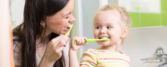 Cute,Mom,Teaching,Child,Teeth,Brushing,In,Bathroom
