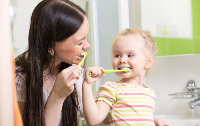 Cute,Mom,Teaching,Child,Teeth,Brushing,In,Bathroom